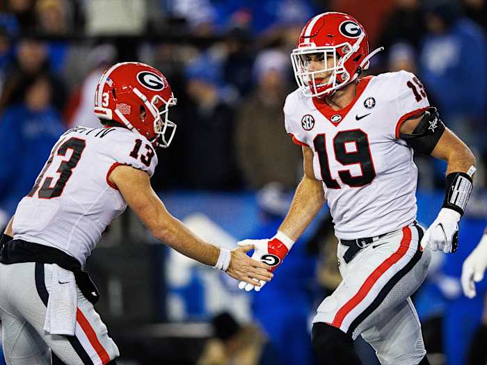 Stetson Bennett and Brock Bowers slap hands